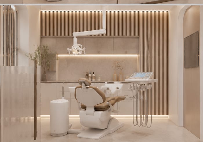 Glass-front operatory with a single dental chair in warm, calm light